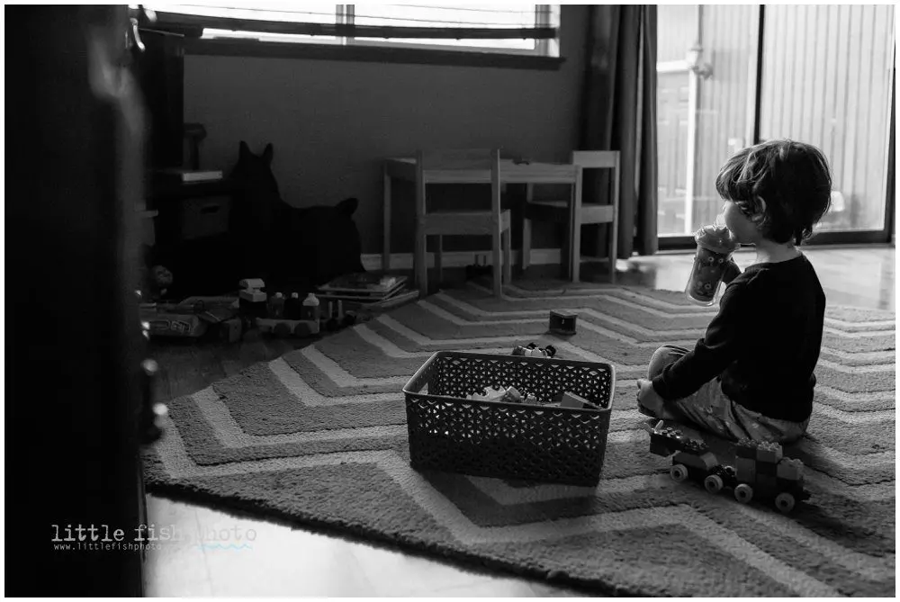 boy watches tv while drinking juice - Poulsbo Lifestyle Photography