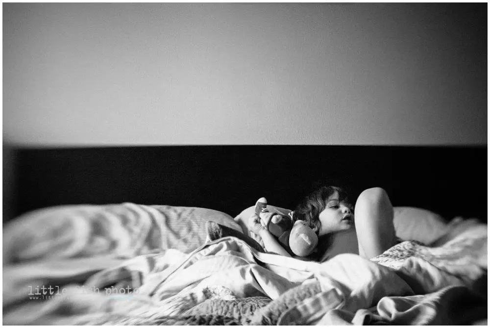 little boy lounges in bed , shot with lensbaby - Poulsbo Lifestyle Photography