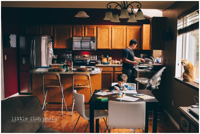 father cooks dinner son draws at kitchen table, life at home - kitsap lifestyle photographer