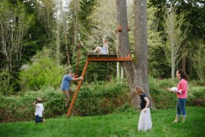 family on backyard zipline