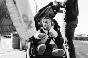 girl eats snack in stroller