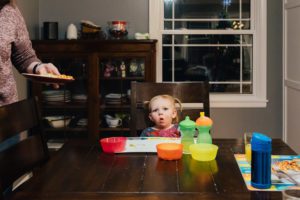 girl makes face at dinner