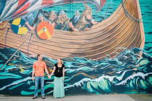 Maternity image of couple against wall mural