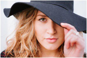 high school girl with hat pulled over eye - Kitsap Lifestyle Photographer