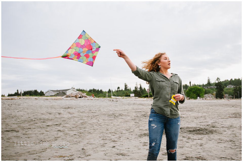 girl on beach flying kite