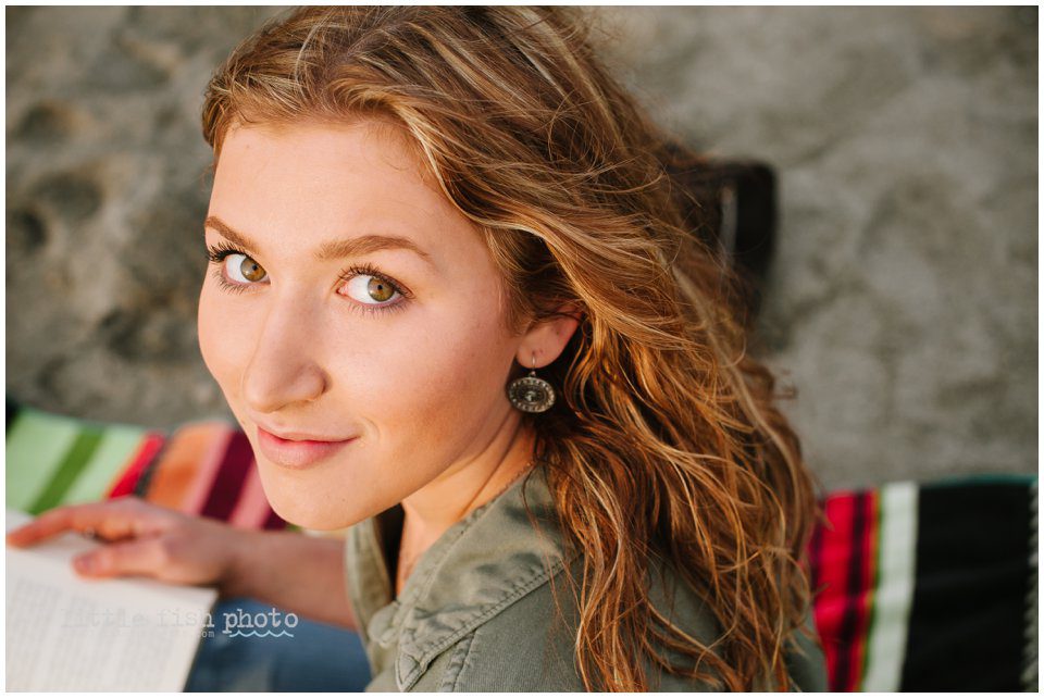 girl on beach reading books