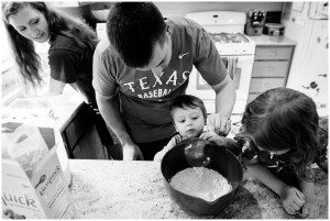 father and kids make pancakes