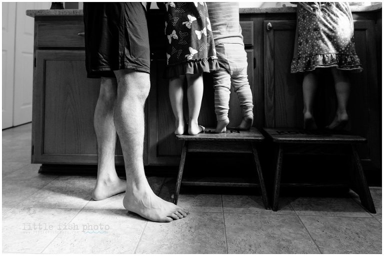 dad and kids stand next to counter while cooking - Family Photography