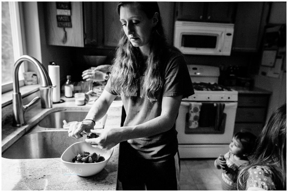 mom cuts strawberries at sink - Documentary Family Photography