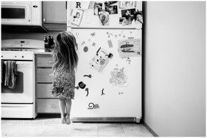girl jumping by refridgerator