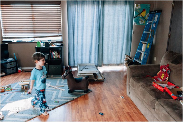 boy running in living room, dog waits to go out