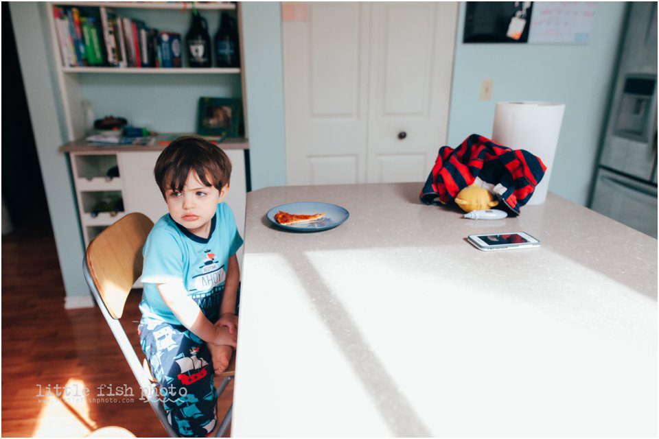 boy displeased with pizza lunch