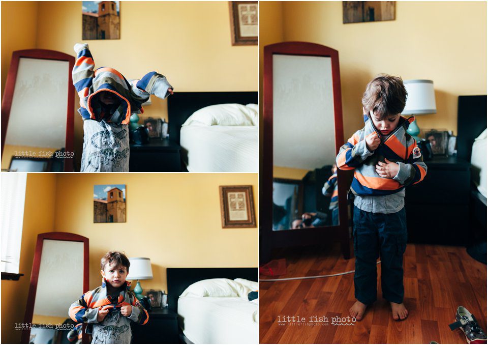 boy puts on sweatshirt