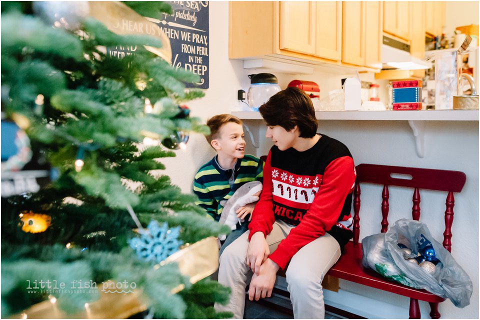 brothers chat near Christmas tree