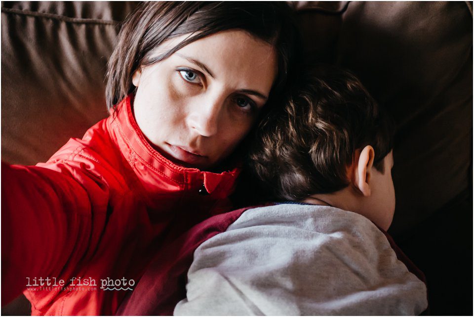 boy asleep in moms lap