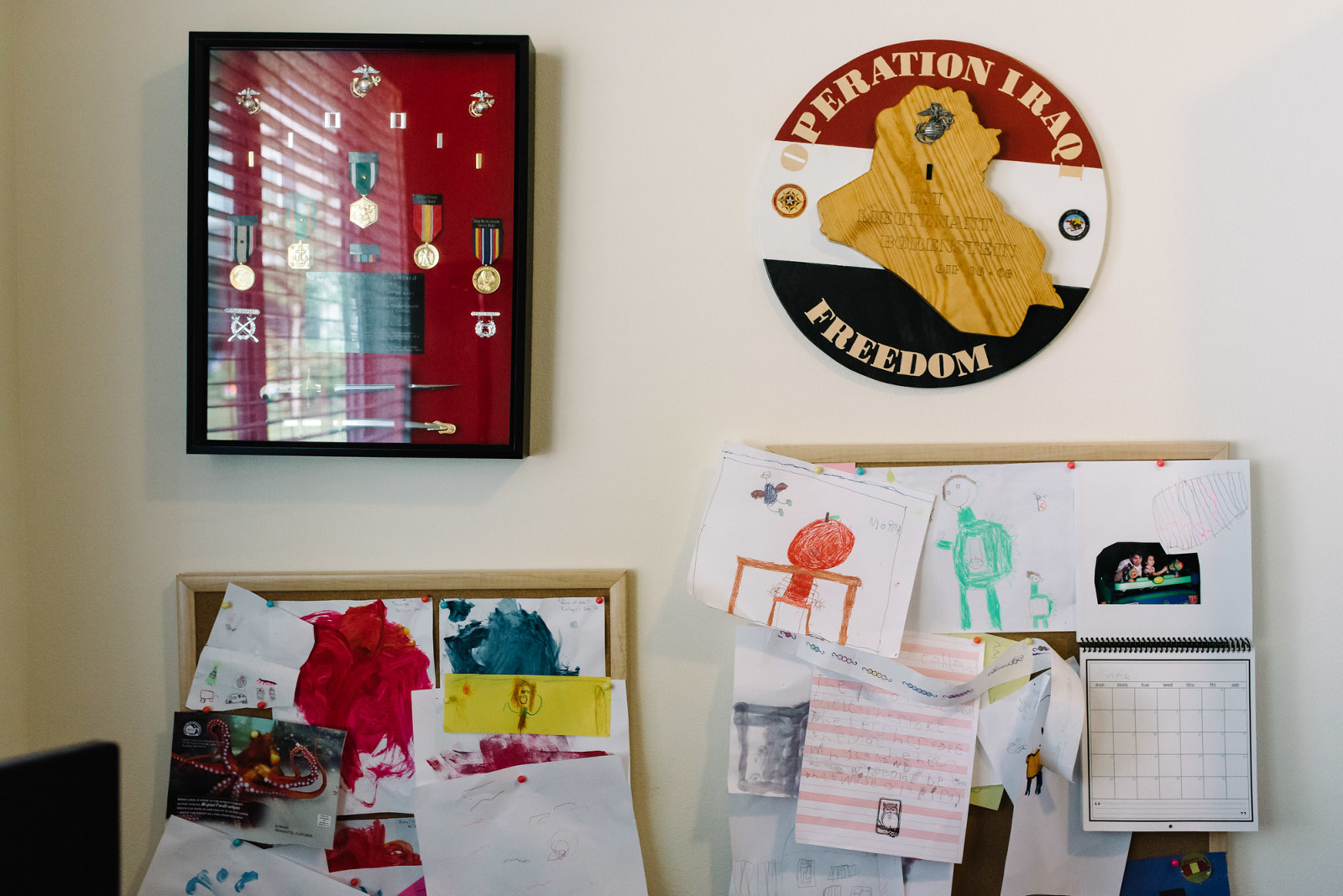 mother's marine plaques above child's drawings.