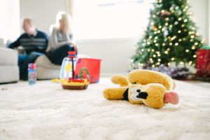 pluto on floor with family in background