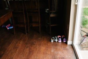 kids shoes lined up near door