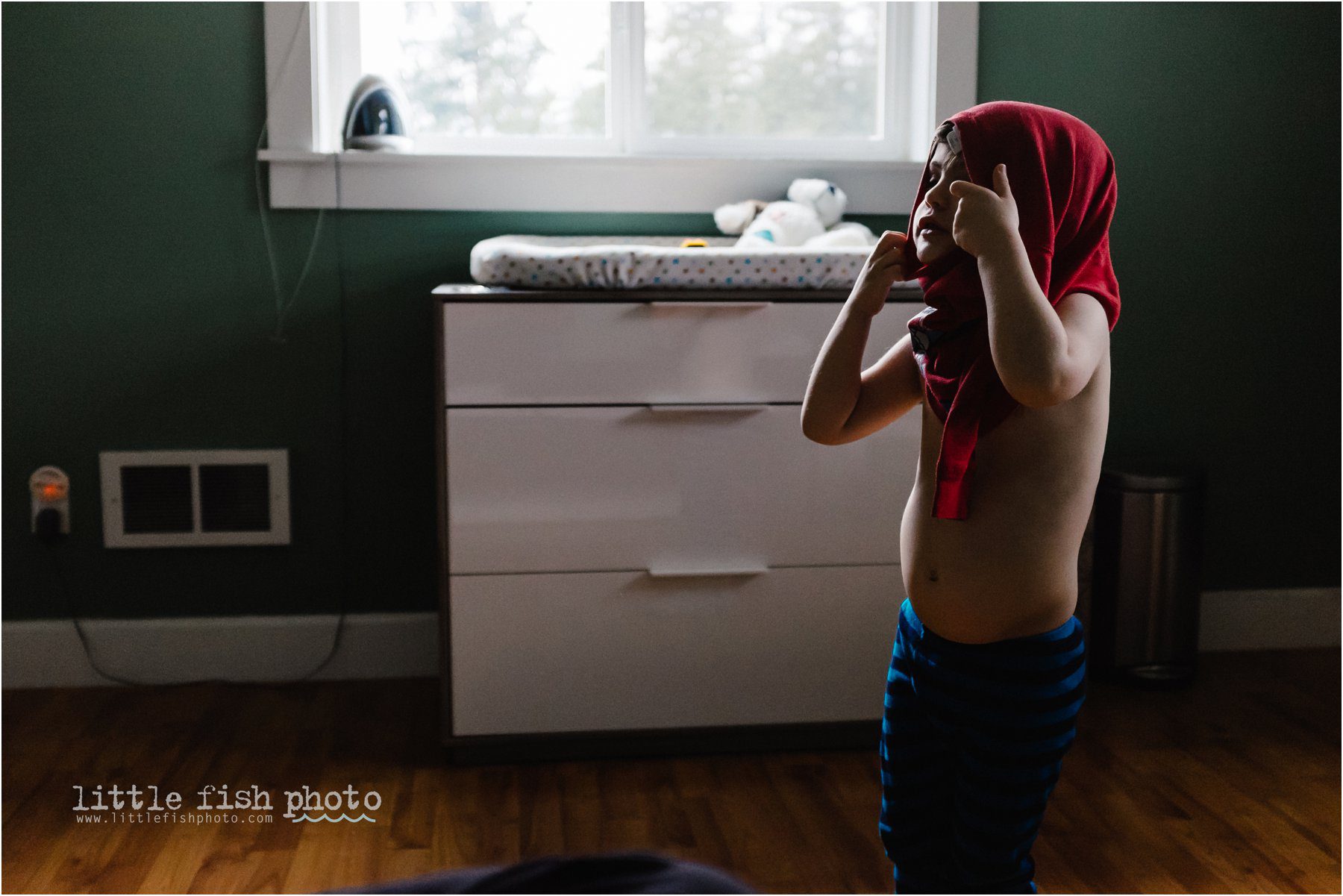 boy putting on shirt