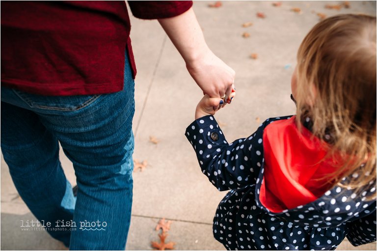 little girl holds mother's hand - Documentary Family Photographer