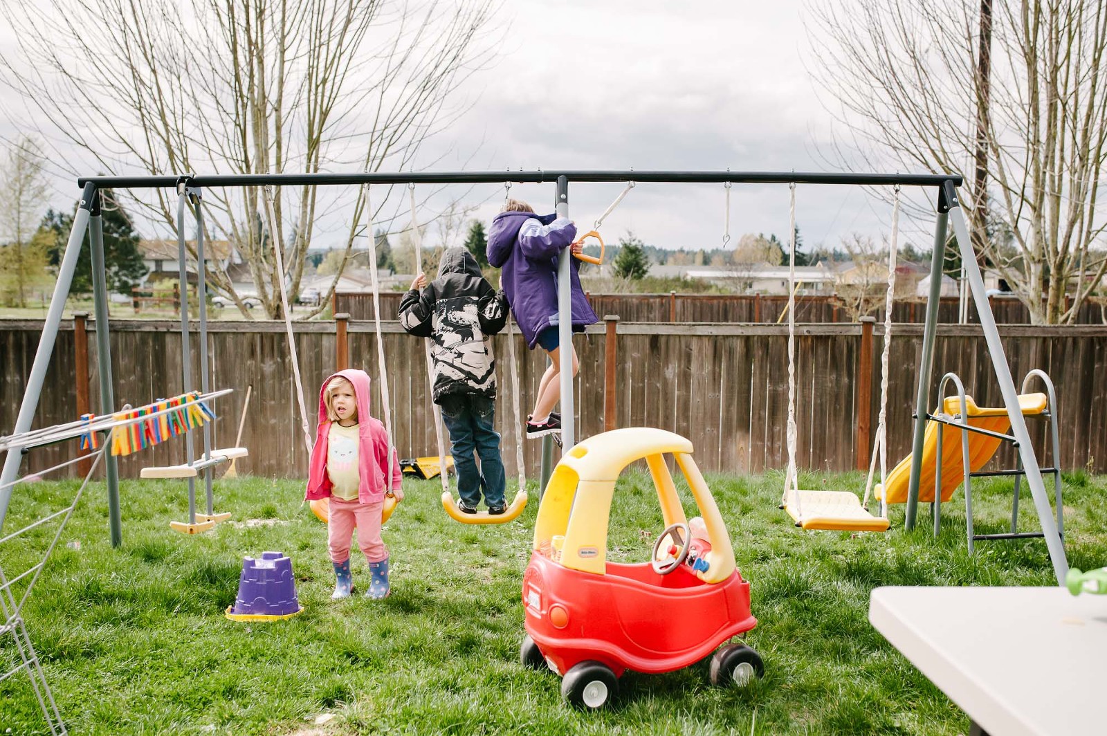 kids on swing set in back yard