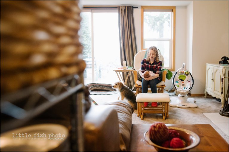 mom holds baby in rocking chair - Bainbridge Island documentary baby photographer 