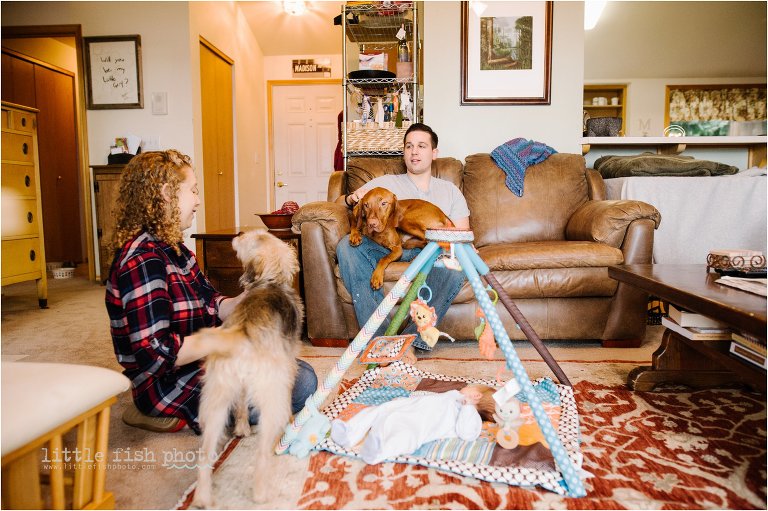 family with baby and dogs in living room - Bainbridge Island documentary baby photographer