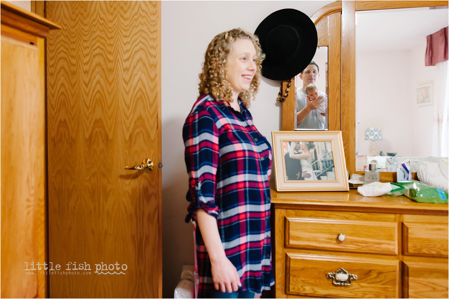 father holds baby in reflection of mirror -Bainbridge Island documentary baby photographer