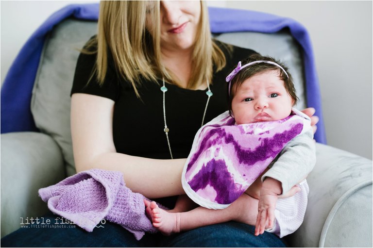 newborn girl is burped in mother's lap - Bremerton Lifestyle Newborn Photographer
