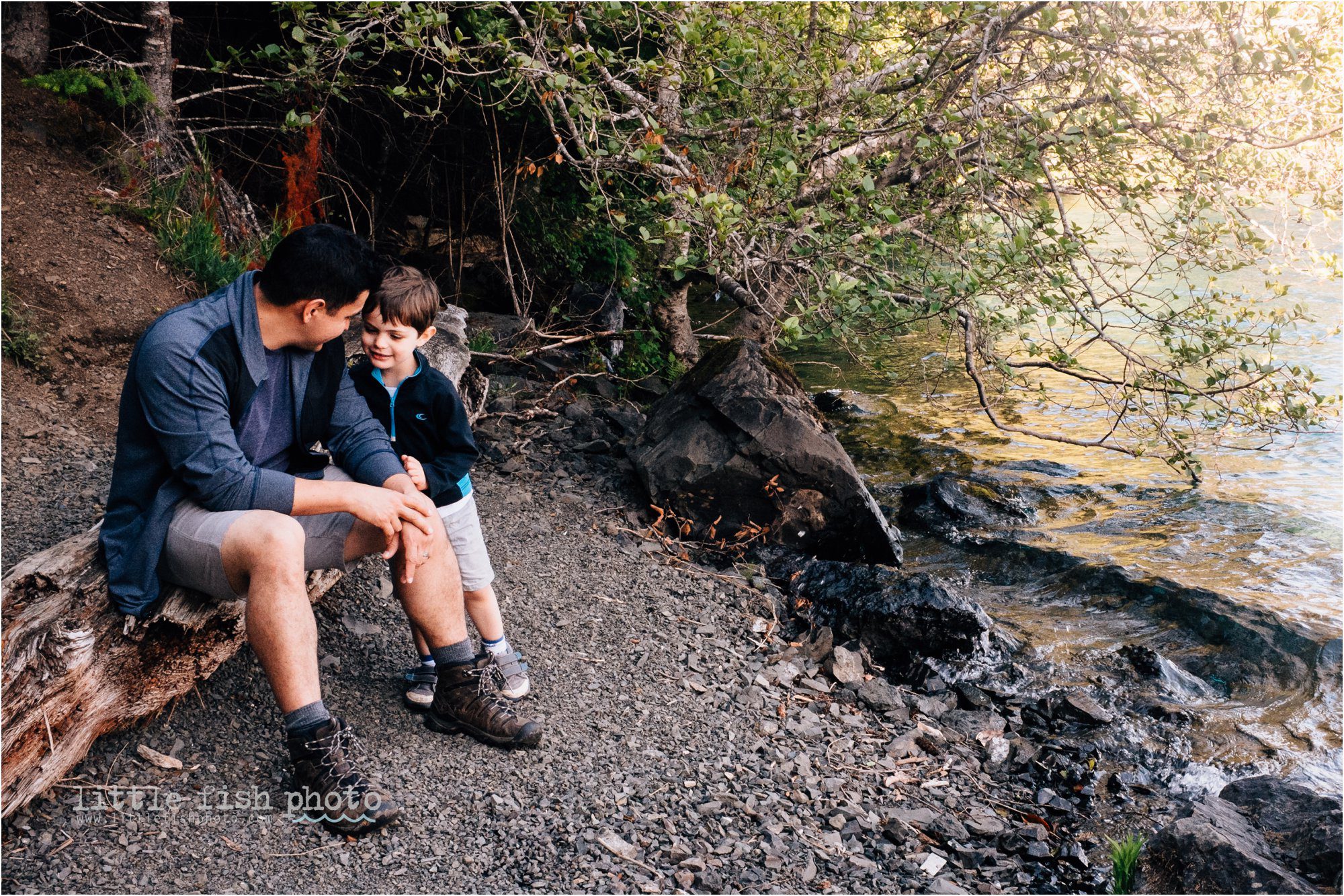 father and son talk on lake shore - Documentary Family Photographer