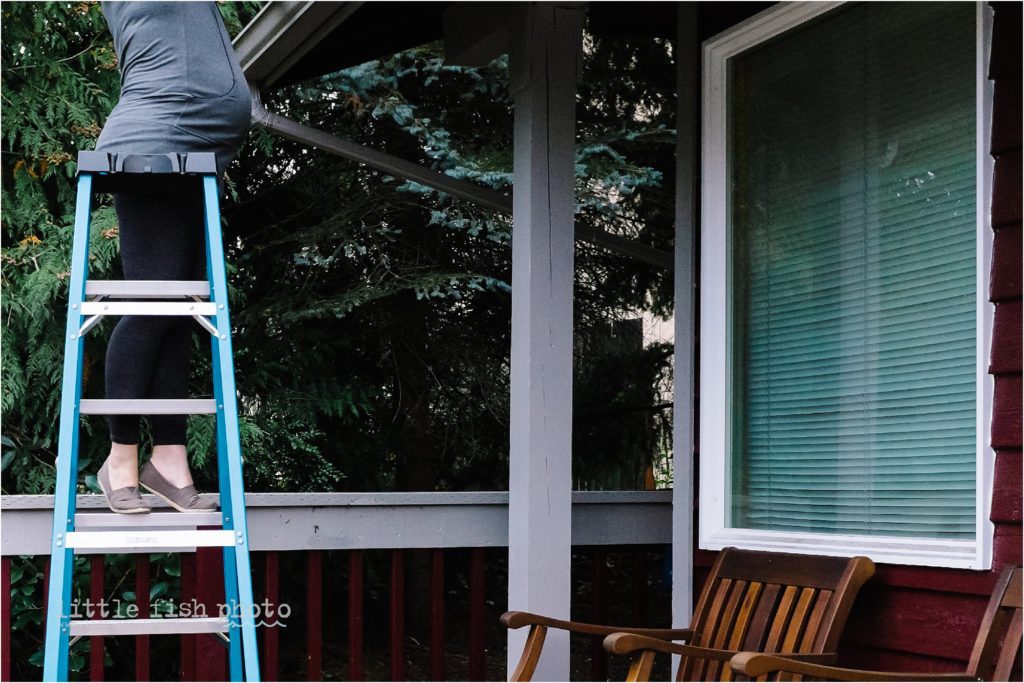 pregnant woman cleans gutters - documentary family photography