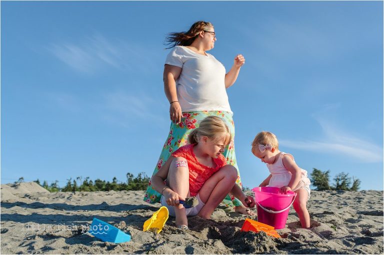 family plays in sand at the beach - Kitsap Lifestyle Family Photographer