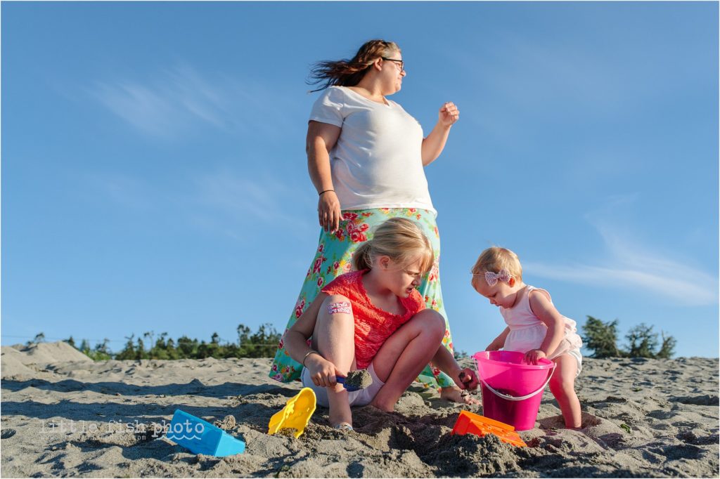 family plays in sand at the beach - Kitsap Lifestyle Family Photographer