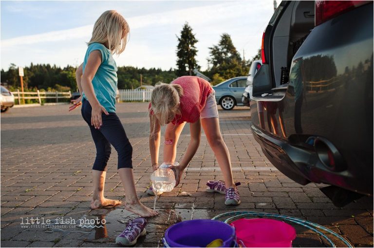 girls clean sand off feet after playing on beach - Kitsap Lifestyle Family Photographer