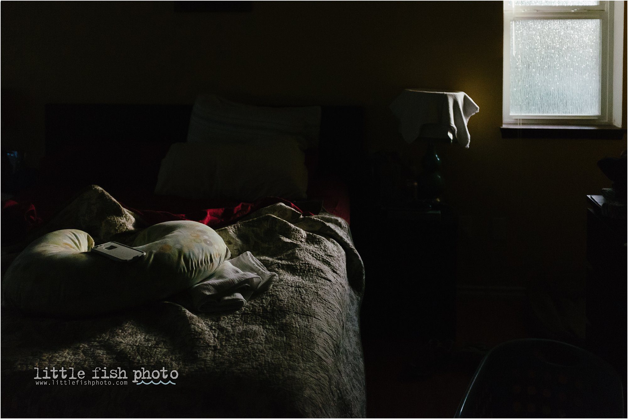 unmade bed in window light