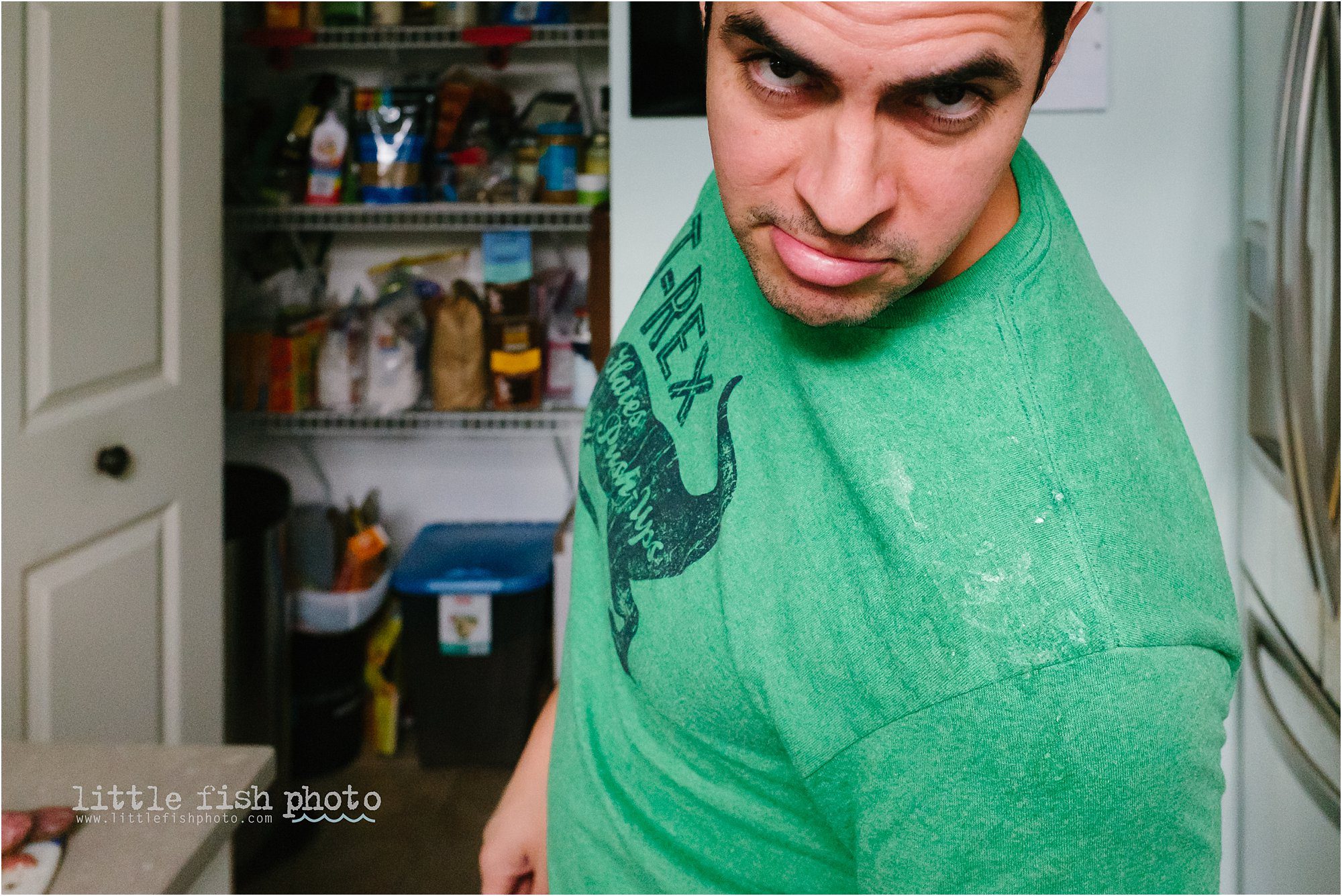 man with baby spit up on shoulder