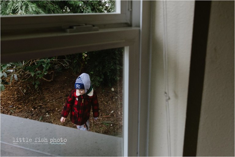child in winter gear from window - Poulsbo Documentary Family Photography