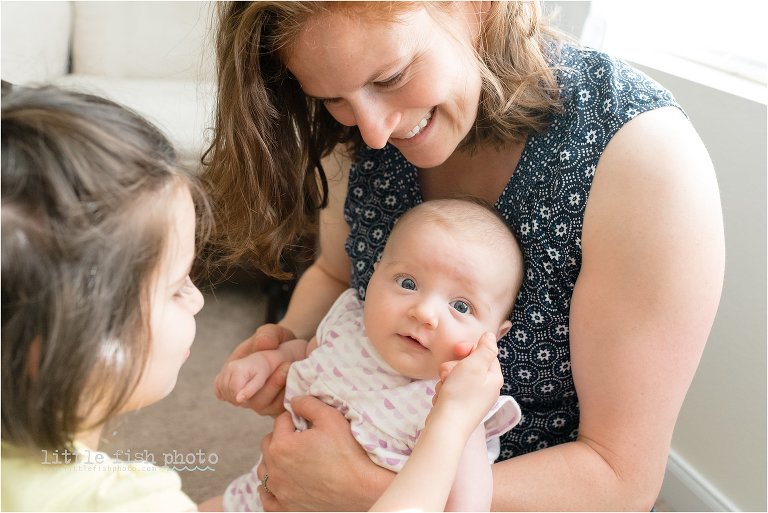 sister and mom bond with baby 