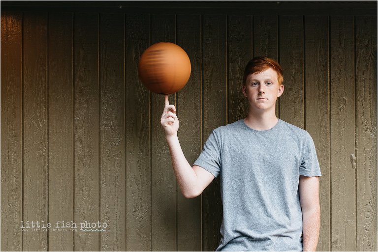 high school boy with red hair spinning basketball - Bainbridge Island High School Senior Photographer
