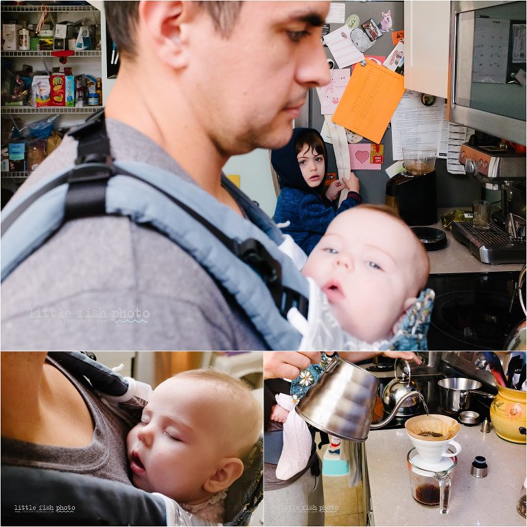 father wears baby while making coffee