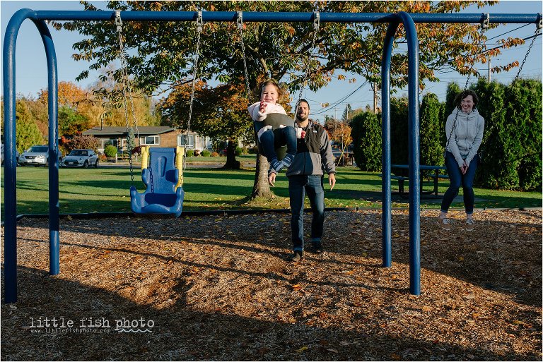 family of three on swings at park - Kitsap Documentary Family Photographer