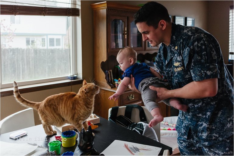 man shows cat to baby - Documentary Family Photography