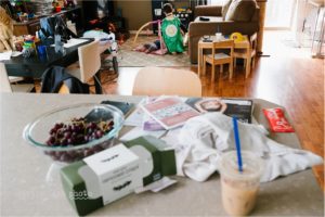 boy in cape attends baby on floor - Documentary Family Photography