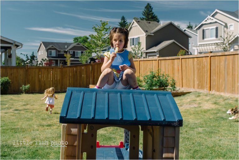 girl eats popsicle on roof of playhouse - Leaving Home - Kitsap Lifestyle Photographer