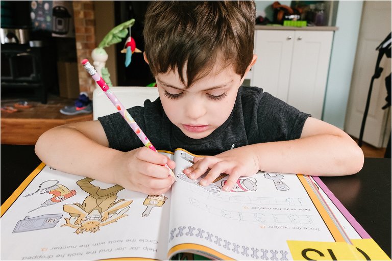 boy works on workbook - Kitsap Documentary Family Photographer