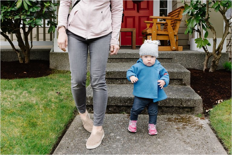 Mother on front doorstep with toddler