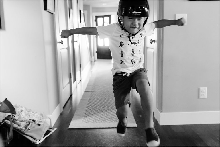 boy jumps in bike helmet - Seattle Documentary Family Photographer