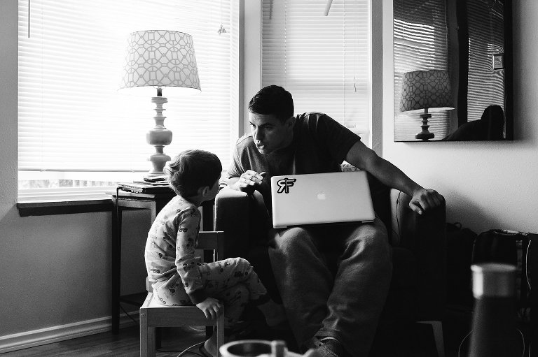 father talks to son while holding laptop - photography website review and development