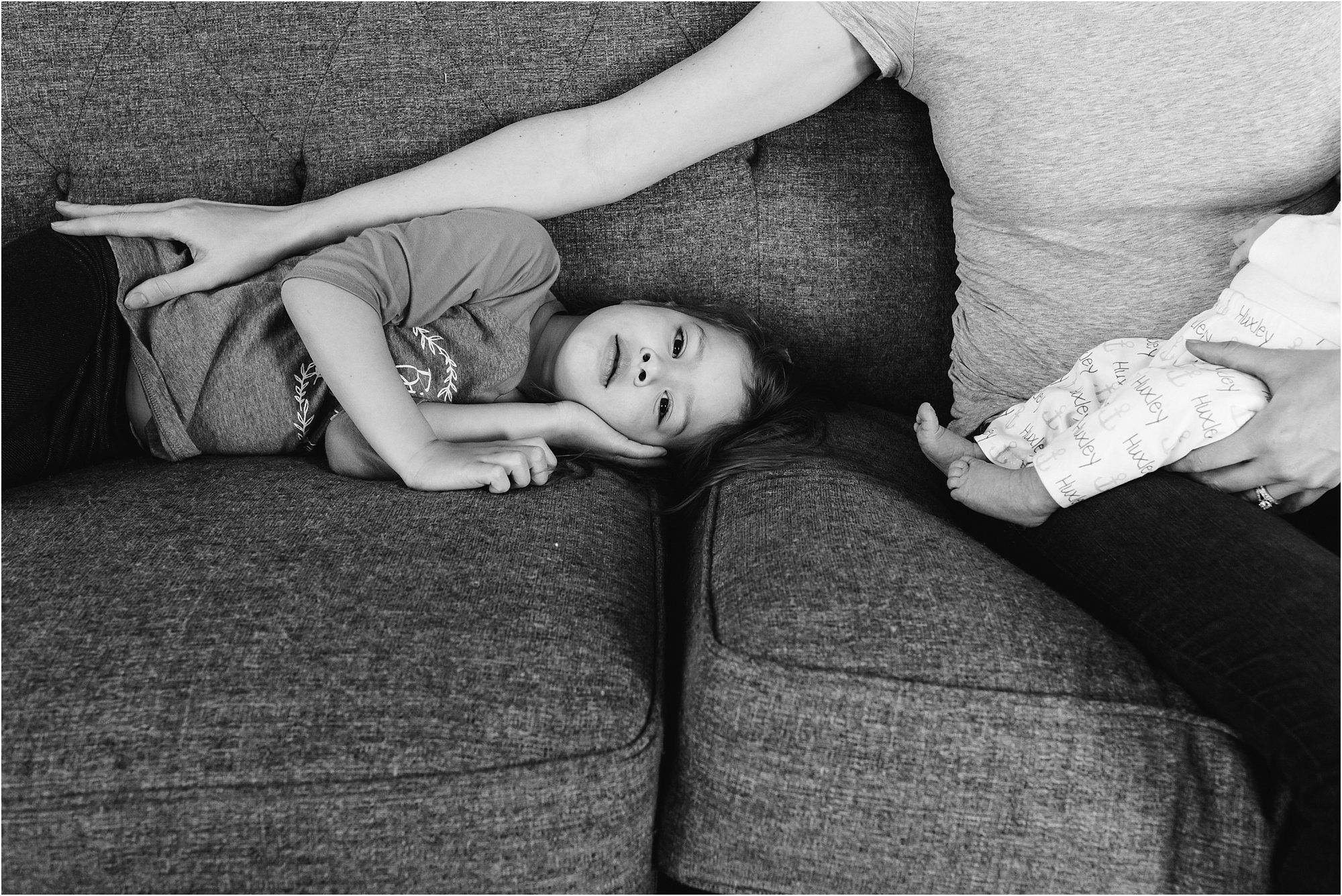 mother reaches for daughter while holding son - Kitsap Newborn Photography