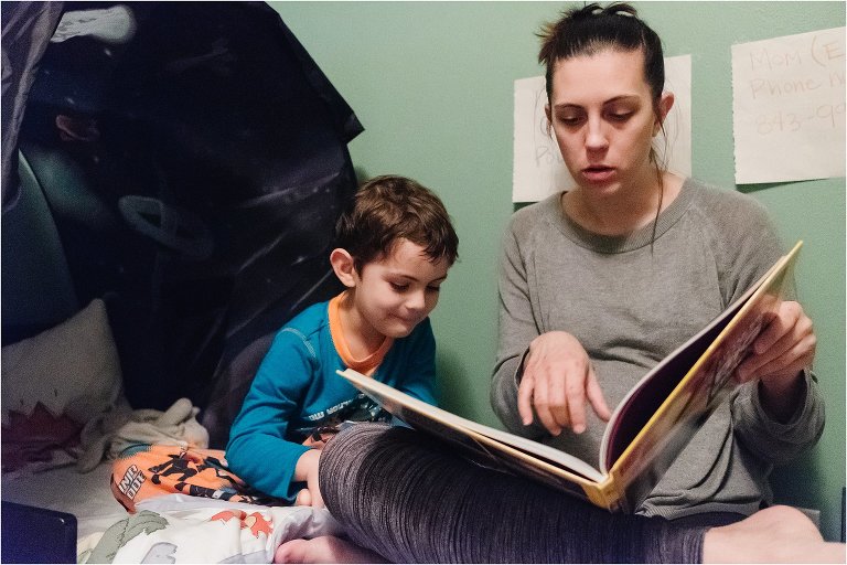 mom reads boy story in bed